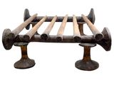 a metal bed with wooden slats on top of it