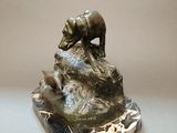a statue of a bear and a bear cub on a rock