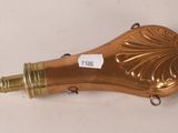 an antique brass plated hair dryer on a white surface