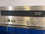 silver oven with four knobs on top of it in a kitchen