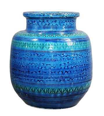 a blue vase that is sitting on a white surface