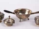 four pieces of silverware on a white surface