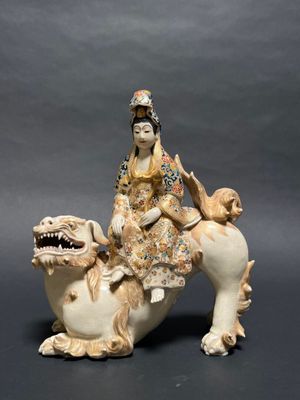 chinese figurine of a woman riding on a horse with a dog