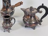 a silver tea pot and a silver coffee pot