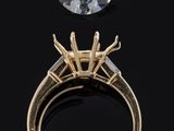 a close up of a ring with a diamond on top of it