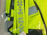 a yellow vest that is sitting in a plastic bag