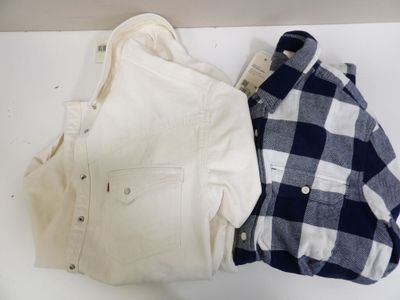 two shirts that are sitting next to each other on a table