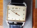 a watch that is sitting on top of a wooden stand