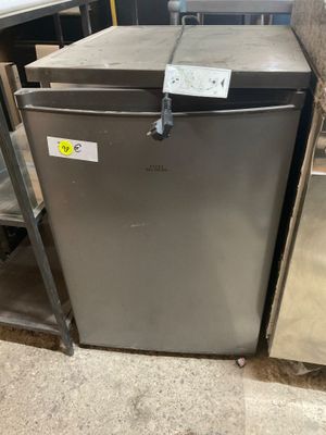 a refrigerator that is sitting in the middle of a room
