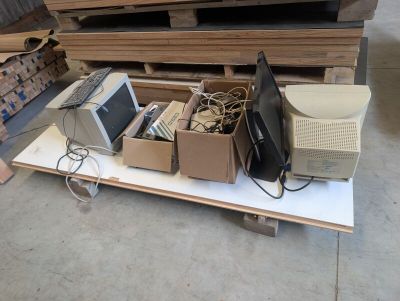 a lot of computers and other electronics on a table