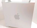 a white apple computer sitting on top of a white table