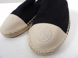 a pair of black and beige espadrills on a white surface