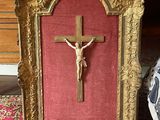 a picture of a crucifix in a gold frame on the floor