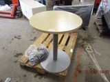 a table that is sitting on a pallet in a warehouse