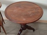 a small table and two stools in a room
