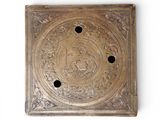 an antique brass plate with a design of a man and a woman on it