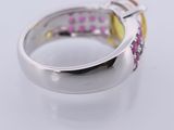 a close up of a ring with pink and yellow stones