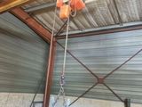 a crane hanging from the ceiling of a building