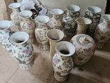 many vases sitting on the floor in a room