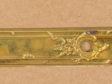 an image of a brass plate with a decorative design on it