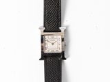 a watch that is sitting on a black leather strap