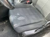 a dirty seat in the back of a car