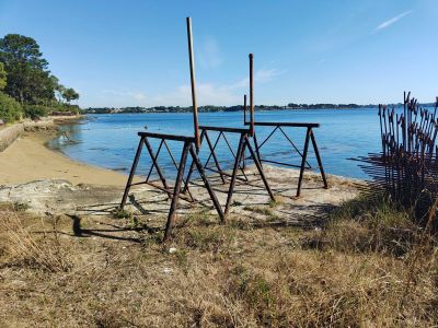 a wooden structure sitting on the shore of a lake