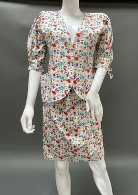 a mannequin dressed in a floral print dress and jacket
