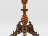 a wooden table with a carved top and a wooden base