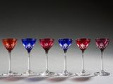 six red, white, and blue wine glasses lined up in a row