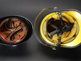 a yellow helmet and a brown helmet sitting next to each other