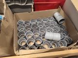 a cardboard box filled with many different types of pipes