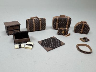 several pieces of louis vuittois luggage sitting on top of a table