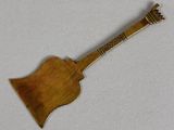 an old wooden guitar shaped broocher with a metal handle