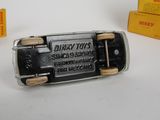 a silver and black cell phone sitting next to a yellow box