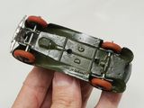 a person holding a toy car in their hand