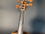 an old violin with a bow on a black background