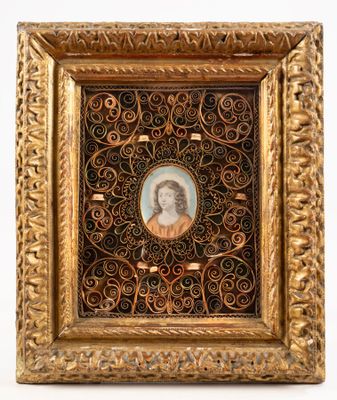 an old picture of a woman in a gold frame on a white background