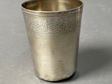 a silver cup that is sitting on a table