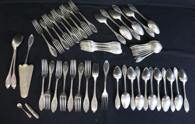 a lot of silver spoons and forks laid out on a table