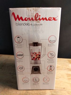 the box of the blender is sitting on the table