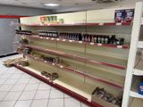 many empty shelves in a grocery store that are empty
