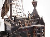 a model of a pirate ship on display on a table