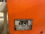 a close up of an orange machine with a label on it