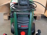 a green and black power washer sitting on the floor