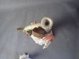 a small figurine of a bird with a hat on it ' s head