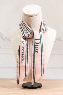 a close up of a mannequin with a pink and green striped scarf on it