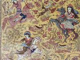 a close up of a rug with a picture of people riding horses