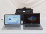 two laptops that are sitting on a table