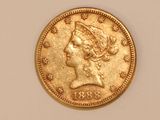 a close up of a gold coin with a woman ' s head on it